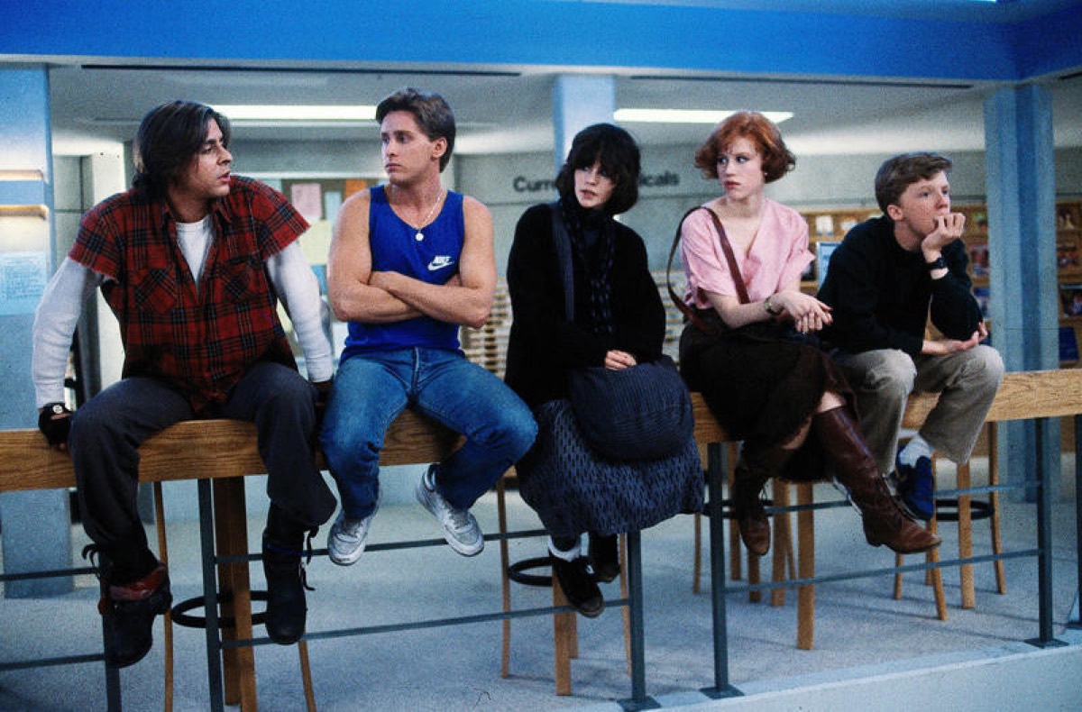 Five teenagers seated in a row in a school library