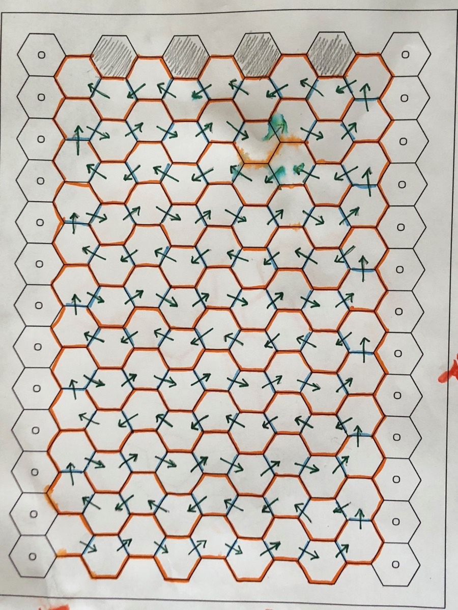 A hexagonal grid drawing with red pen corrections