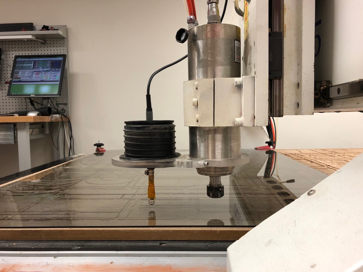 A CNC router cutting a panel