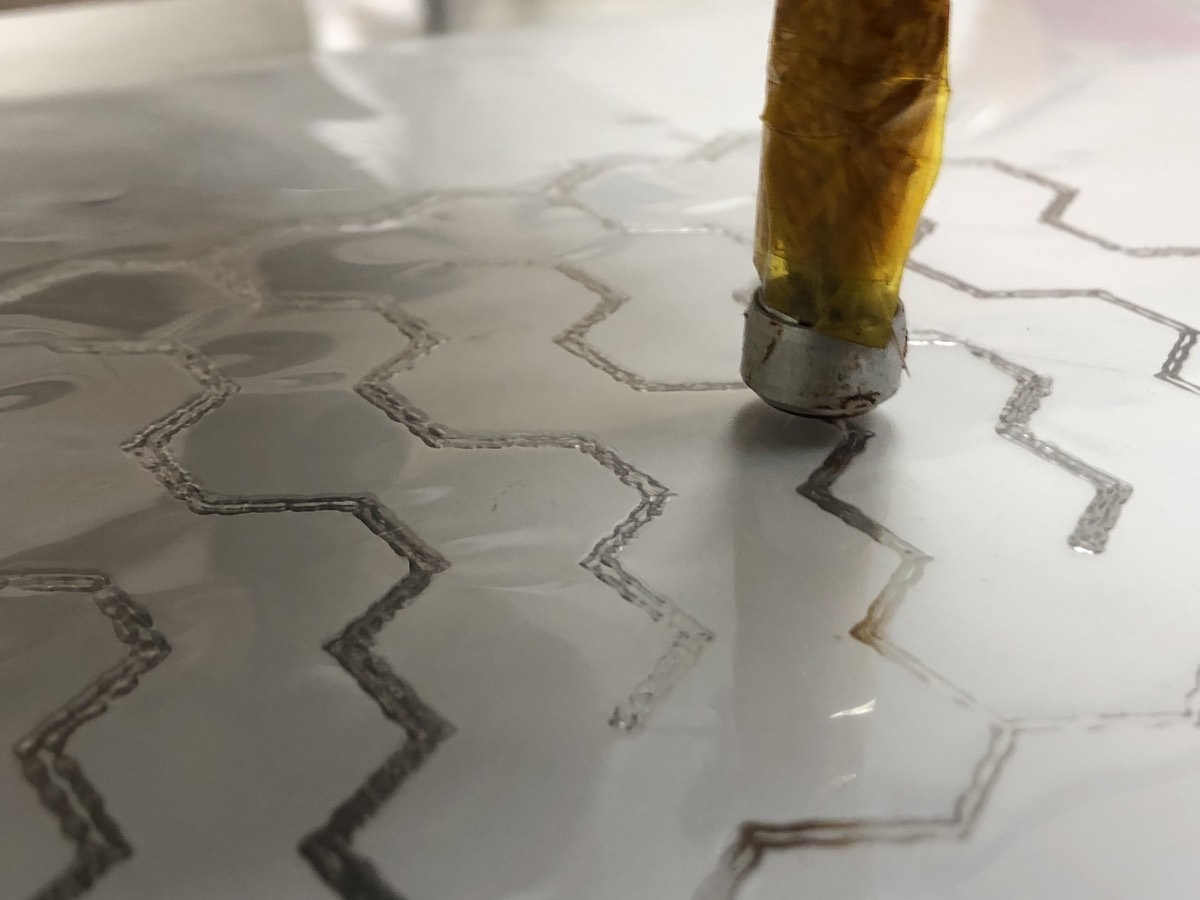 A router bit in acrylic, chips flying